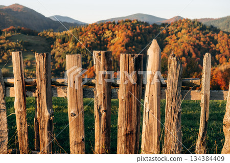Wooden fence is in the Carpathian mountains, autumn season Wooden fence is in the Carpathian mountains, autumn season 134384409