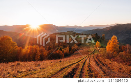 Sun is over horizon. Majestic view of Carpathian mountains, autumn season Sun is over horizon. Majestic view of Carpathian mountains, autumn season 134384450