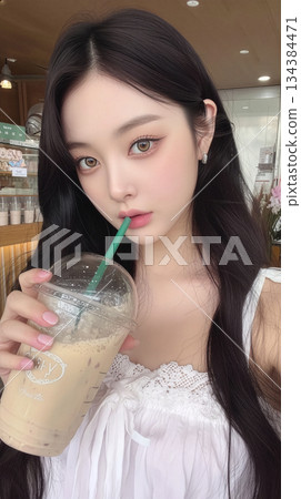 A selfie of a young, pretty woman drinking a drink at a cafe. Vertical, Instagram-style. 134384471