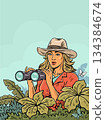 Woman with binoculars in jungle scene with copy space 134384674