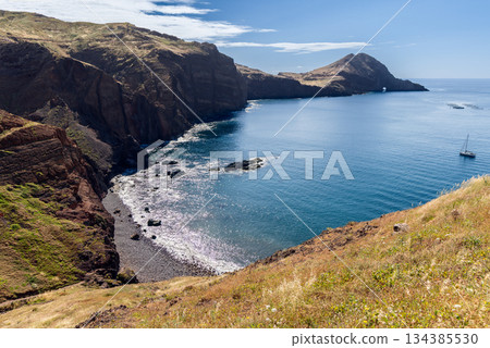 Turquoise Atlantic bay in Sao Lourenco Madeira with rocky shore and quiet sailboat Turquoise Atlantic bay in Sao Lourenco Madeira with rocky shore and quiet sailboat 134385530