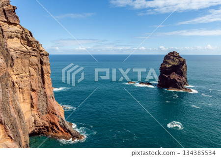Warm volcanic cliffs Sao Lourenco Madeira contrast with cool Atlantic blue sea stack Warm volcanic cliffs Sao Lourenco Madeira contrast with cool Atlantic blue sea stack 134385534