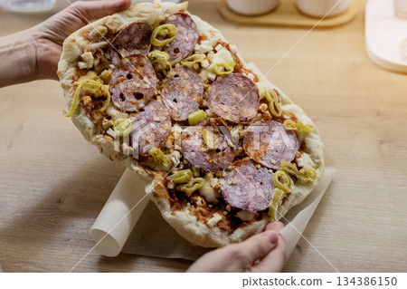 Raw thin crust pinsa with pepperoni Raw thin crust pinsa with pepperoni 134386150