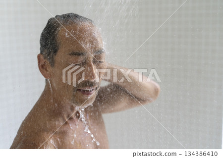 Senior man taking a shower 134386410