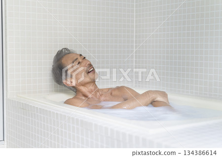 A man in his 60s taking a bath 134386614