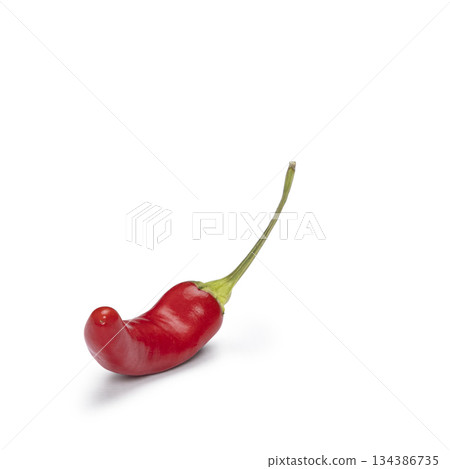 Red spicy chili pepper with stem on white background Red spicy chili pepper with stem on white background 134386735