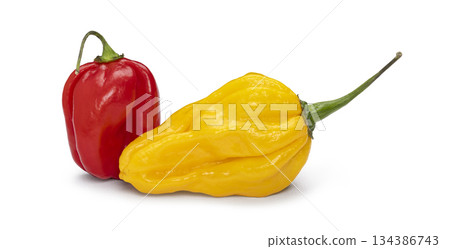 Red habanero and yellow aji limon chili peppers on white 134386743