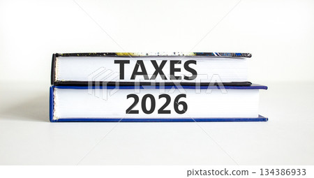 Taxes 2026 new year symbol. Concept words Taxes 2026 on beautiful books. Beautiful white paper background. Business and taxes 2026 new year concept. Copy space. Taxes 2026 new year symbol. Concept words Taxes 2026 on beautiful books. Beautiful white paper background. Business and taxes 2026 new year concept. Copy space. 134386933