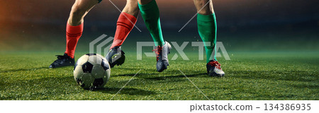 Focused football footwork drill with controlled ball movement. 134386935