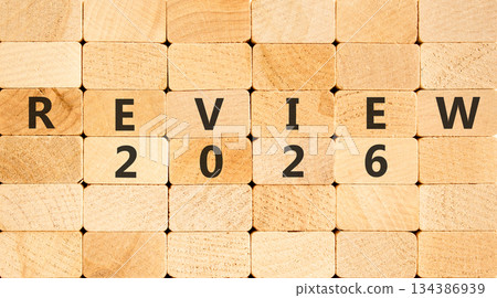 Review 2026 symbol. Concept words Review 2026 on beautiful wooden blocks wall. Beautiful wooden blocks wall background. Business and review 2026 concept. Copy space. 134386939