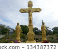 An Orthodox cross with the crucifixion of Jesus Christ stands on a pedestal 134387372