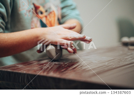 Child Sculpting Clay with Hands on Table Child Sculpting Clay with Hands on Table 134387603