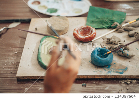 Handcrafting Clay Bowls and Art with Paintbrushes Handcrafting Clay Bowls and Art with Paintbrushes 134387604