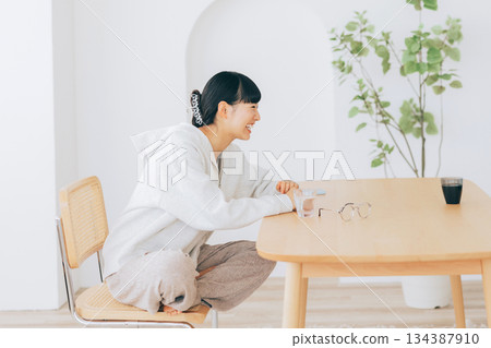 Women chatting at the living room table Women chatting at the living room table 134387910