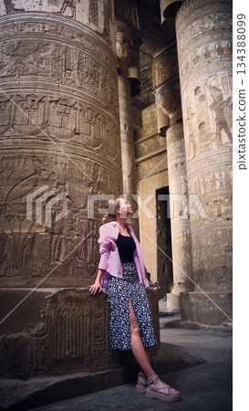 Woman Standing Between Ancient Stone Columns Woman Standing Between Ancient Stone Columns 134388099
