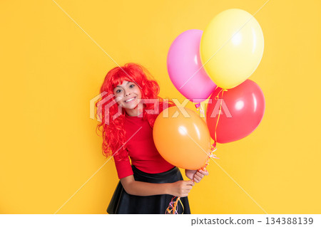 positive kid with party balloon on yellow background positive kid with party balloon on yellow background 134388139