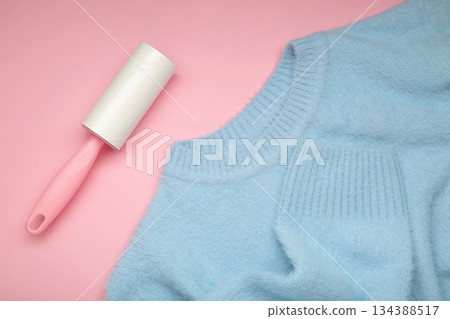 Lint roller on blue texture background to remove pet animal hair. 134388517