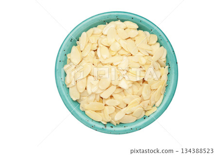 Fresh almond flakes in plate isolated on white background, closeup Fresh almond flakes in plate isolated on white background, closeup 134388523