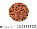 Almonds in white bowl isolated on white background 134388535
