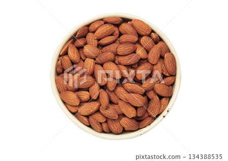 Almonds in white bowl isolated on white background Almonds in white bowl isolated on white background 134388535