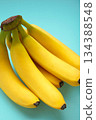 Bunch of bananas on mint background. Top view. Vertical photo 134388548