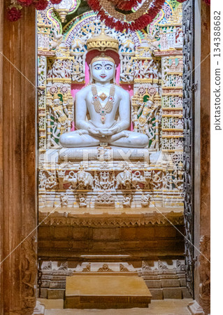 India, Interior of a Jain temple, marble statue of a Jain figure, Tirthankara, seated in meditation posture, lotus 134388682