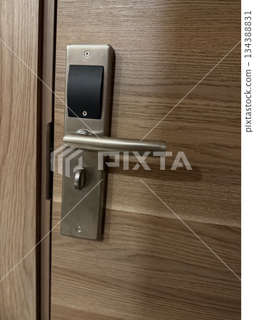Door handle and lock on wooden surface, ideal for home security concepts or background Door handle and lock on wooden surface, ideal for home security concepts or background 134388831