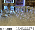 Glassware arrangement with empty wine glasses and beer glasses in bar setting background Glassware arrangement with empty wine glasses and beer glasses in bar setting background 134388874