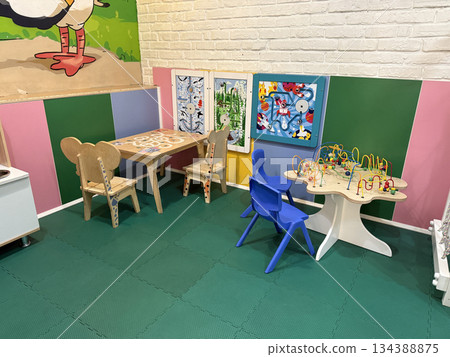 Preschool playroom with colorful walls, tables, and educational toys, suitable for background 134388875