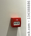 Fire alarm button on white wall with sunlight shadow, suitable as background Fire alarm button on white wall with sunlight shadow, suitable as background 134388886