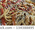 Asian noodle dish with sesame seeds, bell peppers, and chicken, ideal for food background Asian noodle dish with sesame seeds, bell peppers, and chicken, ideal for food background 134388895