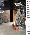 Christmas tree decorated with ornaments and gifts in modern office lobby background Christmas tree decorated with ornaments and gifts in modern office lobby background 134388897