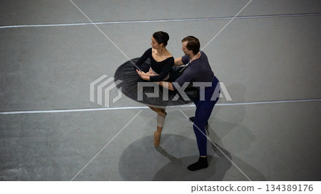 Ballet partners refining rotation technique in studio space 134389176