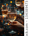Person is holding wine glass with lot of glitter in it. Festive and celebratory mood, as it is party or special occasion 134389473