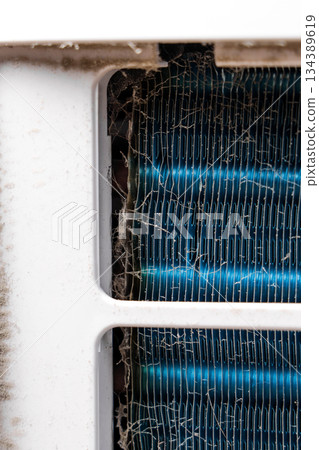 Dusty heat exchanger radiator inside home air dehumidifier. Clogged fins. Maintenance concept Dusty heat exchanger radiator inside home air dehumidifier. Clogged fins. Maintenance concept 134389619