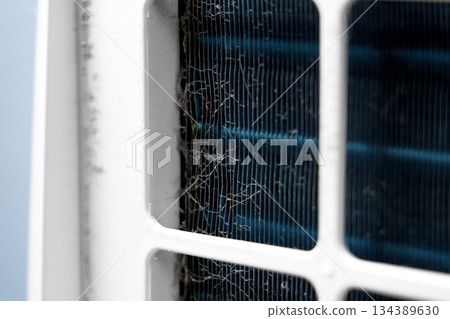 Contaminated dusty metal fins inside residential air treatment device closeup Contaminated dusty metal fins inside residential air treatment device closeup 134389630