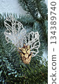 green pine cone on snow 134389740