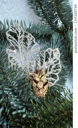 green pine cone on snow 134389740