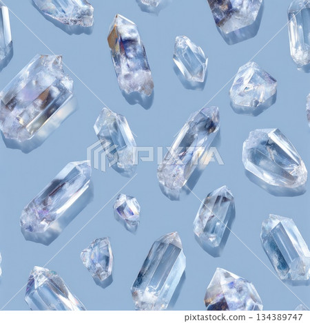 Seamless pattern featuring clear quartz crystals on a soft blue background in an abstract design Seamless pattern featuring clear quartz crystals on a soft blue background in an abstract design 134389747