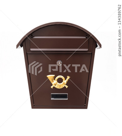 Vintage brown metal mailbox with a golden post horn emblem and curved roof, isolated on a white background. Vintage brown metal mailbox with a golden post horn emblem and curved roof, isolated on a white background. 134389762