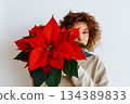 young woman with a flowerpot Christmas star 134389833