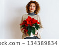 young woman with a flowerpot Christmas star 134389834