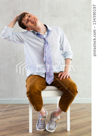 Male employee stretching at office chair at work, tired office worker Male employee stretching at office chair at work, tired office worker 134390197