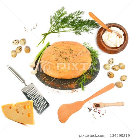 Flat Lay of Round Cheese Bread with Ingredients and Utensils 134390219