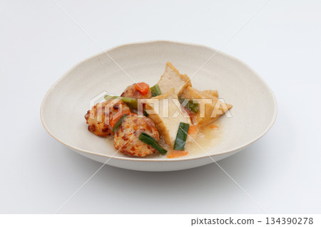 Deep-fried tofu and chicken meatballs simmered in thick sauce on a white background Deep-fried tofu and chicken meatballs simmered in thick sauce on a white background 134390278