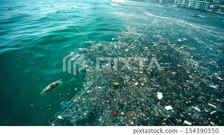 The ocean is full of floating trash and plastic waste. View from above. Concept of catastrophic water pollution The ocean is full of floating trash and plastic waste. View from above. Concept of catastrophic water pollution 134390350