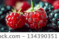 Ripe raspberries and blackberries covered in dew. Macro photography. Shallow focus highlights their vibrant texture 134390351