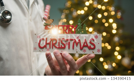 Cardiologist Doctor Wishes Merry Christmas in Front of Glowing Tree Cardiologist Doctor Wishes Merry Christmas in Front of Glowing Tree 134390415