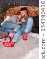 Happy Couple Enjoying Cozy Evening, Lovers Snuggling Together With Festive Decorations And Gentle Smiles 134390416
