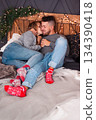 Intimate Moment With Cozy Comfort, Casual Couple Resting Together With Cheerful Socks And Charming Rustic Decor 134390418